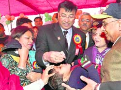 ArcelorMittal chairman LN Mittal gives polio drops to a child at a health camp in New Delhi 