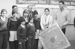 Students of residential bridge course school being given a carrom board at Salora village, Ropar, on Thursday.