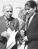 Anand Prakash, petitioner in the Ruchika case, discusses the matter with a lawyer at the district courts in Panchkula on Thursday.