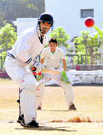 A batsman prepares to play a shot in a match of the 58th District Cricket League in Dehradun on Thursday