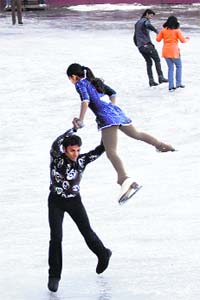 A pair performs during a gala figure skating at the ice skating rink in Shimla