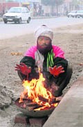 A man warms himself on the Bibiwala road in Bathinda on Thursday. 