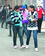 The students of BBK DAV College share a light moment on a chilly day in Amritsar. 