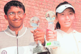 Mohit Mayur Jayaprakash, India, and (right) Zi Yang, China, with their trophies after winning the India ITF Grade 3 World Junior Ranking Tennis Tournament in Chandigarh on Friday.