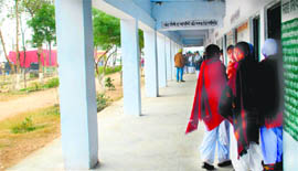 Students of government school, Jhanjheri, stand out of their classes during a public hearing session in the school on Friday.