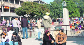 People enjoy the sun at plaza in Sector 17, Chandigarh, on Friday.