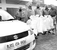 Police officials with seize poppy husk at Rajpura on Friday.