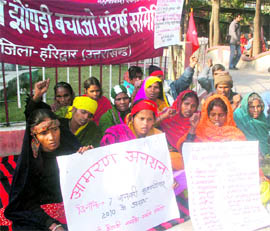 Members of the Jhuggi-Jhopdi Bachao Sangharsh Samiti hold a protest in Haridwar on Friday