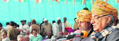 Chief Minister BS Hooda addresses party workers at Chopta on Friday. Congress nominee for Ellenabad Bharat Singh Beniwal stands next to him