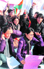 Activists of various organisations of the Jammu and Ladakh regions shout slogans in front of Raj Bhawan in Jammu