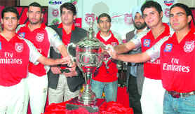 The captains with the trophy on Friday. 