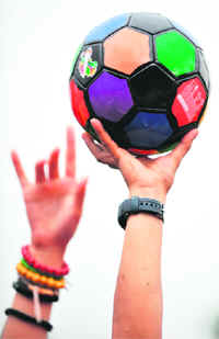 Indonesian youths hold a ball as they attend a ceremony to welcome the FIFA World Cup Trophy Tour to Jakarta on Friday. The 2010 FIFA World Cup will take place between 11 June and 11 July 2010 in South Africa.