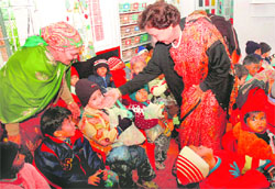 Underprivileged children receive shoes, sweaters and refreshments from Governors wife Jean Rodrigues at a function in Chandigarh on Saturday.