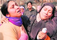 Relatives wail over the death of a teenage boy, who was allegedly injured in firing by the CRPF and later died in hospital, in Srinagar