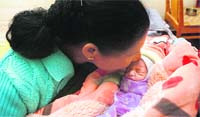 Newborn baby girl Vaishali in the cosy embrace of Lissy John at SOS Children Village at Gole Gujral in Jammu on Saturday. Vaishali was reportedly abandoned by her parents one hour after her birth. 