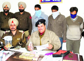 DSP Narinder Singh shows the recovered cash and gold ornaments in Ludhiana on Saturday.