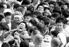 A devotee shouts as he holds the rope that pulls the carriage of the Black Nazarene during a procession in Manila on Saturday. A large number of devotees thronged the streets as a centuries old black statue of Jesus Christ, believed to have healing powers, was paraded through the old city
