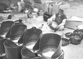 A worker assembles traffic lights at Dera Bassi