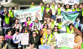 Activists of the Citizens for Green Doon stage a dharna at Connaught Place in Dehradun on Sunday.