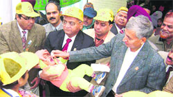Satish Chandra, Principal Secretary, health and family welfare, administers polio drops to a child at a civil dispensary at Malerkotla, near Ahmedgarh, on Sunday