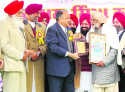 Punjab Governor and Chandigarh Administrator Gen SF Rodrigues (retd) honours litterateur Om Parkash Gaso during the annual Sabhyacharak Mela at Ripudaman Stadium at Patiala on Saturday. 