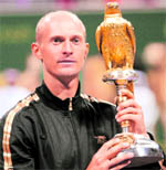 Nikolay Davydenko holds the winners trophy after defeating Rafael Nadal during the final of the Qatar ATP Open in Doha on Saturday