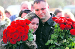 A relative comforts the widow (left) of Bobi Tsankov, a radio presenter who was shot dead, during the funeral of her husband in Sofia, on Sunday. Tsankov, a radio presenter who wrote a book on Bulgarian gangsters, was shot dead in Sofia on Tuesday, in the first such killing since the new government took office in July