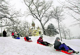 Children enjoy fresh snow in Prague, Czech Republic, on Saturday. Severe winter weather continued to cause havoc across large parts of Europe with snow clogging roads and airports