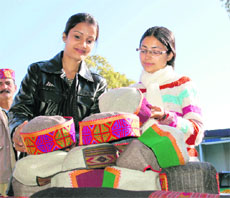 Young girls looking at Himachali handicrafts on display at an exhibition in police grounds at Dharamsala. 