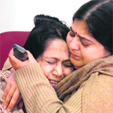 A relative of Dr Himanshu, who has been arrested in connection with the suicide of a DIGs daughter, consoles his mother in Jammu on Monday. 