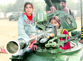 Schoolchildren have a look at a tank on display in connection with Army Day observed by 15 Infantry Division in Amritsar cantonment on Monday.