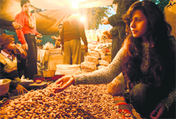 A girl buys groundnuts ahead of Lohri in Chandigarh on Tuesday.
