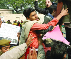 Delhi policemen arrest protesting students outside the Australian High Commission in New Delhi on Tuesday.