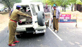Policemen check vehicles in Ellenabad.