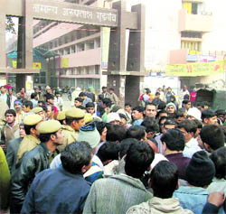 Residents and relatives of Krishan Kumar gather outside the Civil Hospital in Gurgaon on Tuesday.