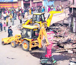 JCB machines dismantle shops amid a protest by shopkeepers at the Bhiwani Stand Market in Rohtak on Tuesday.