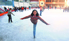 A girl performs a delicate manoeuvre in the skating rink during the Shimla ice skating carnival