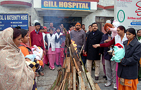 Parents participate in one of the Lohri bashes to celebrate the birth of baby girls.