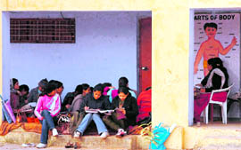 Students study in a verandah in a bone chilling weather in Government Girls School, Satwari colony, in Jammu