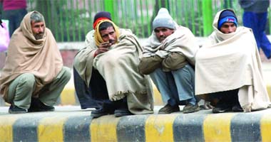 Wrapped in shawls, this group beats the cold at Parliament Street in New Delhi