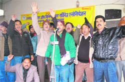Members of the Uttaranchal Federation of Ministerial Services Association hold a protest in Dehradun. 