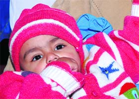 A baby girl at a Lohri function organised by the National Integrated Forum of Artistes and Activists in Karnal