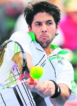 Fernando Verdasco hits a backhand return in his victory over Fernando Gonzalez at the Kooyong Classic tournament, in Melbourne