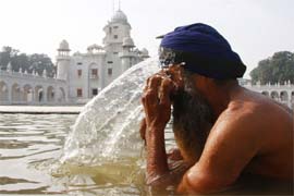 A devotee takes a dip in the holy sarovar at Takht Damdama Sahib in Talwandi Sabo to mark Makar Sankranti
