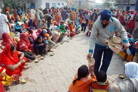 Devotees partake of the langar organised on the occasion of Makar Sankranti at Gurdwara Haji Rattan in Bathinda 