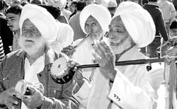 Artistes perform with traditional instruments at Maghi Mela in Dhao village, Kharar.