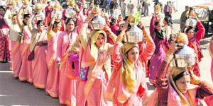 Women carry pots as part of the Jagannath Rath Yatra in Dehradun on Thursday.