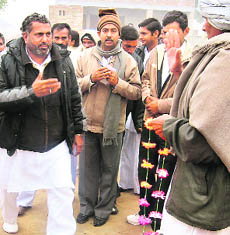 Congress candidate Bharat Singh Beniwal meets voters in Ellenabad on Thursday.