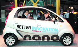 Journalists sit in Tata Nano at the Science Center, where the vehicle was displayed for the first time in the US by Tata Technologies, in Detroit on Thursday.