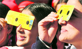 Students of Government Senior Secondary School look at the solar eclipse in Ludhiana on Friday.